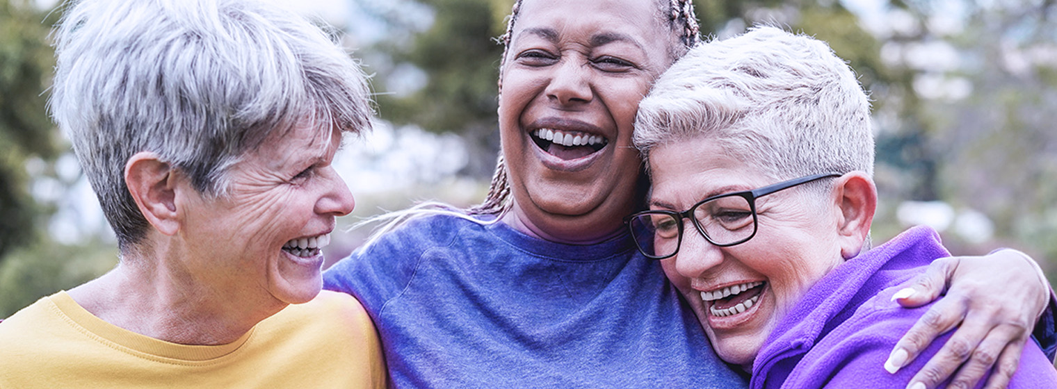a group of older women smile and laugh together
