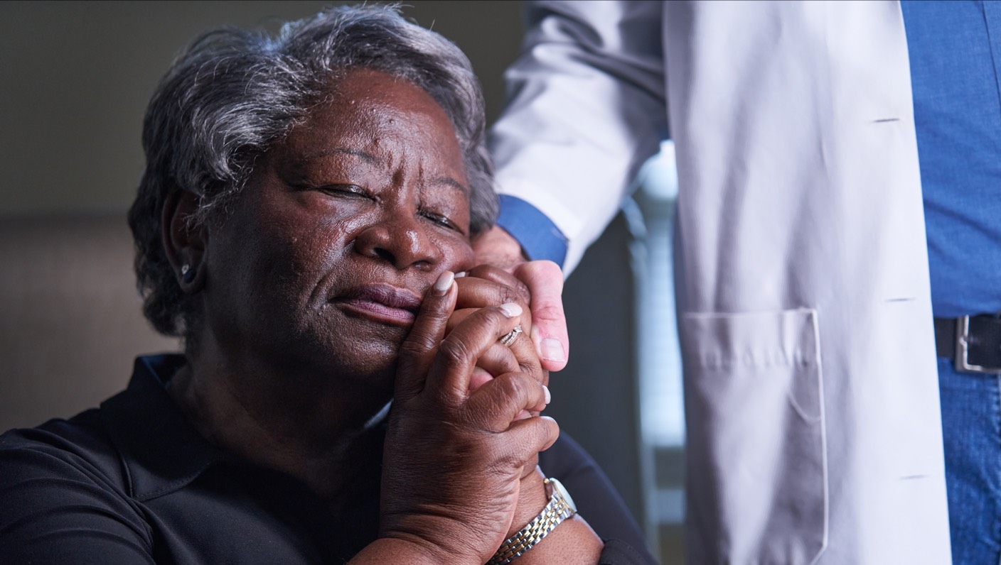 chaplain comforting sitting woman