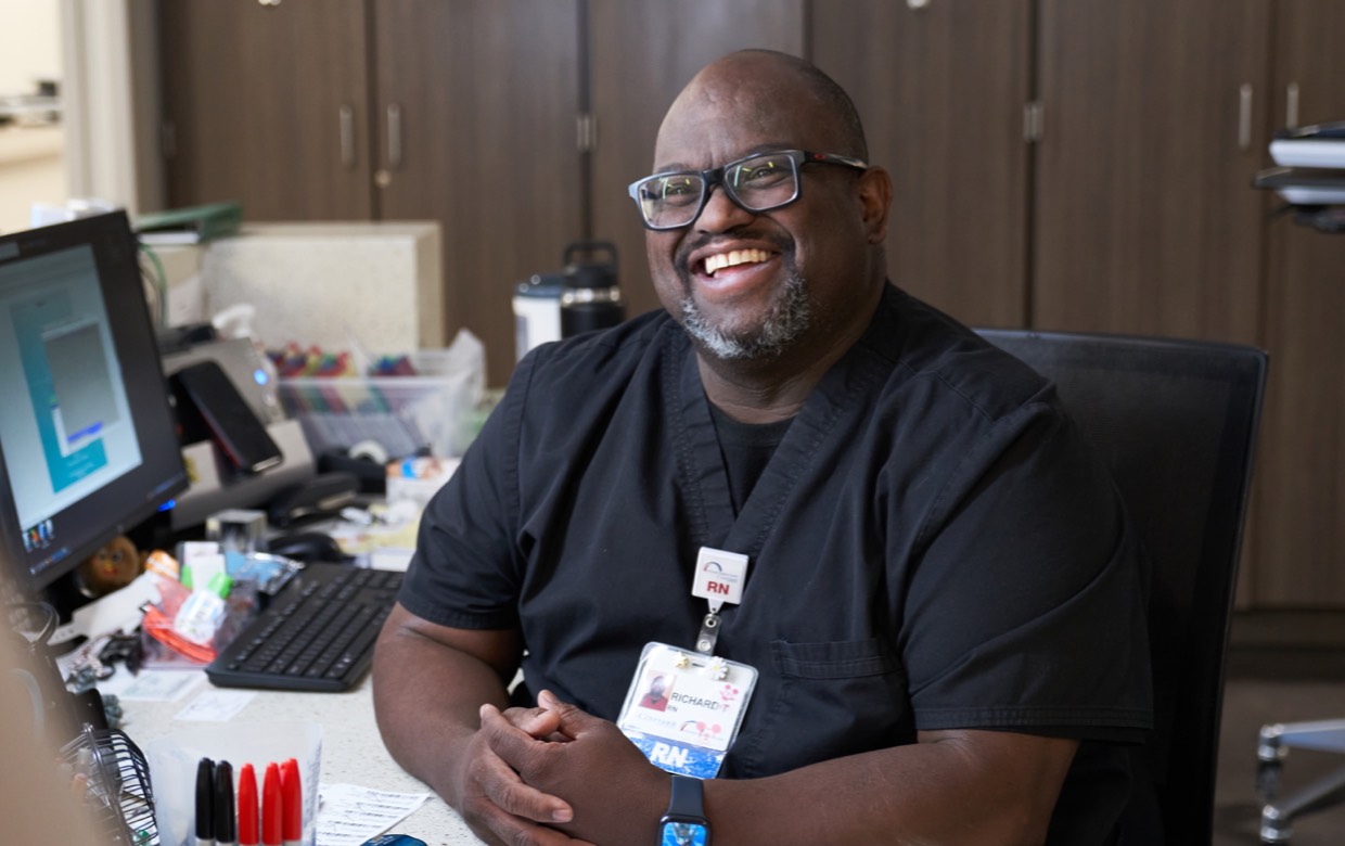 male registration staff member smiling