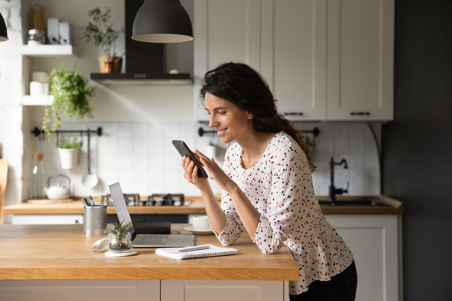 adult women looking at phone in kitchen