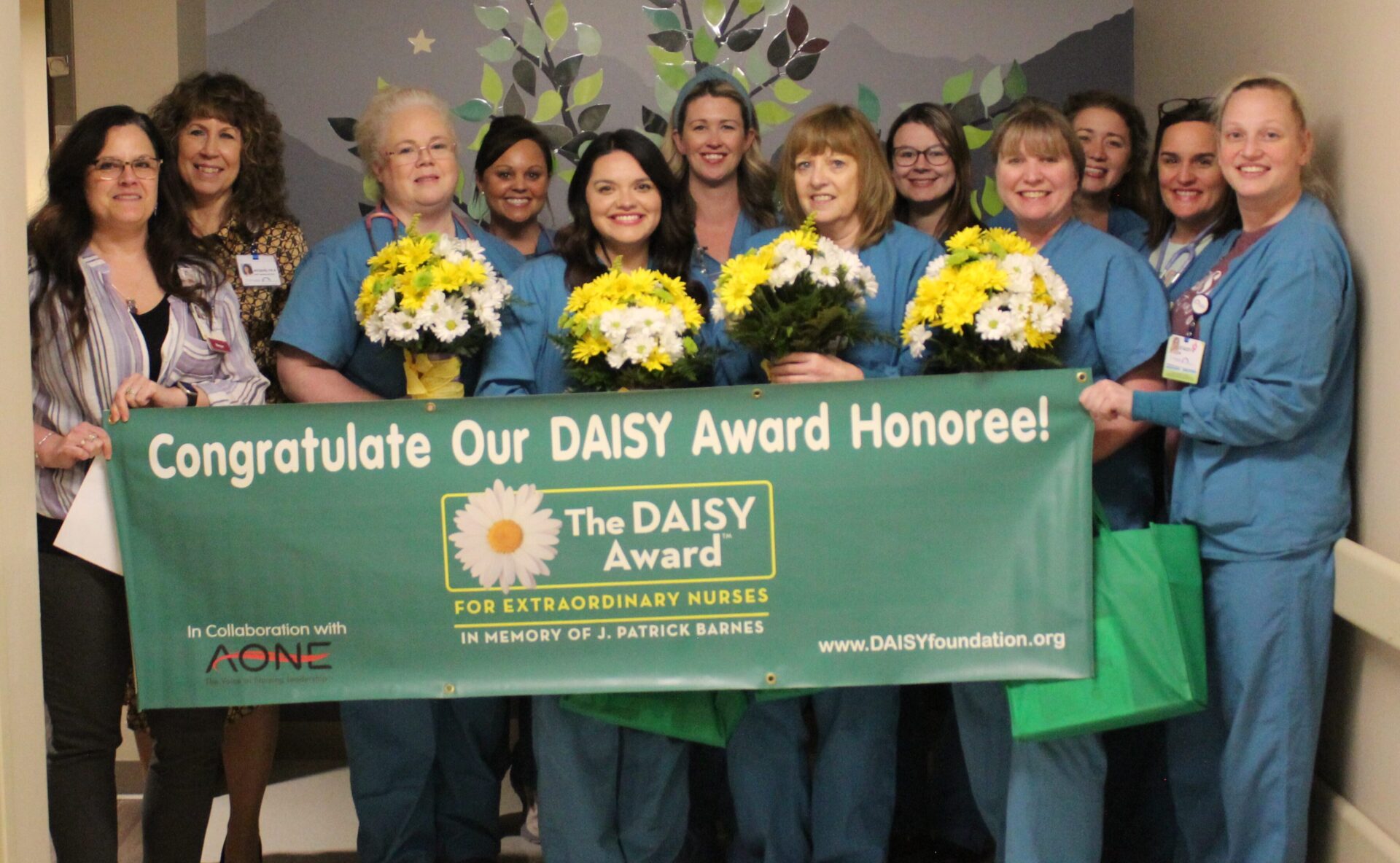 Four DAISY winners pictured holding their beautiful DAISY arrangements.