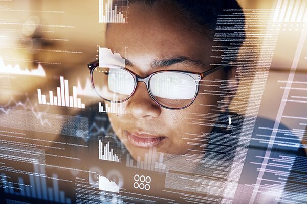 A woman viewing data on her computer screen