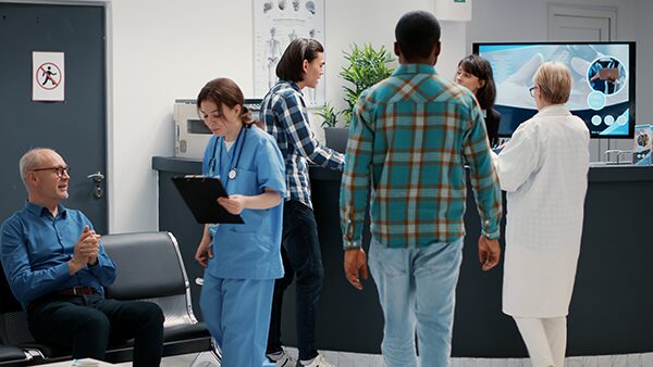 a group of patients waiting in the lobby of a medical clinic.