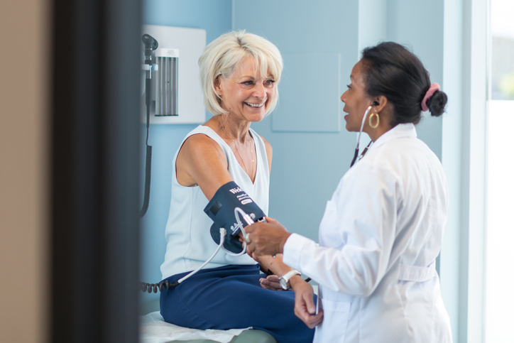 Female provider takes vitals from female patient in doctors office