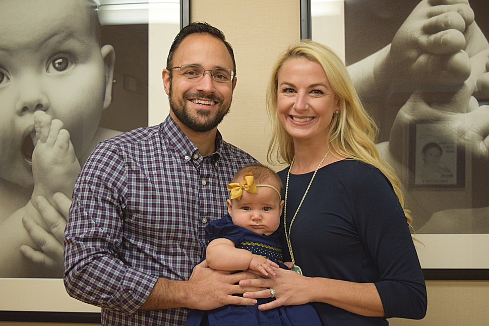 Dr. Andrade and his wife Allison pose with their baby Lyla Mae