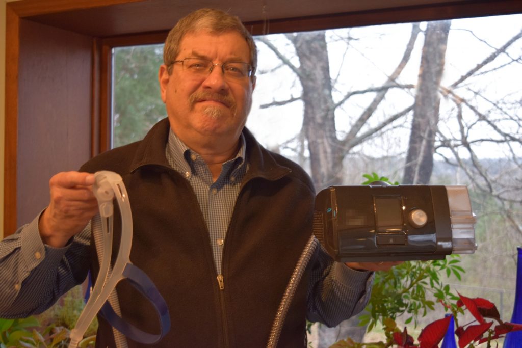 Reed Thomas holds his C-PAP machine