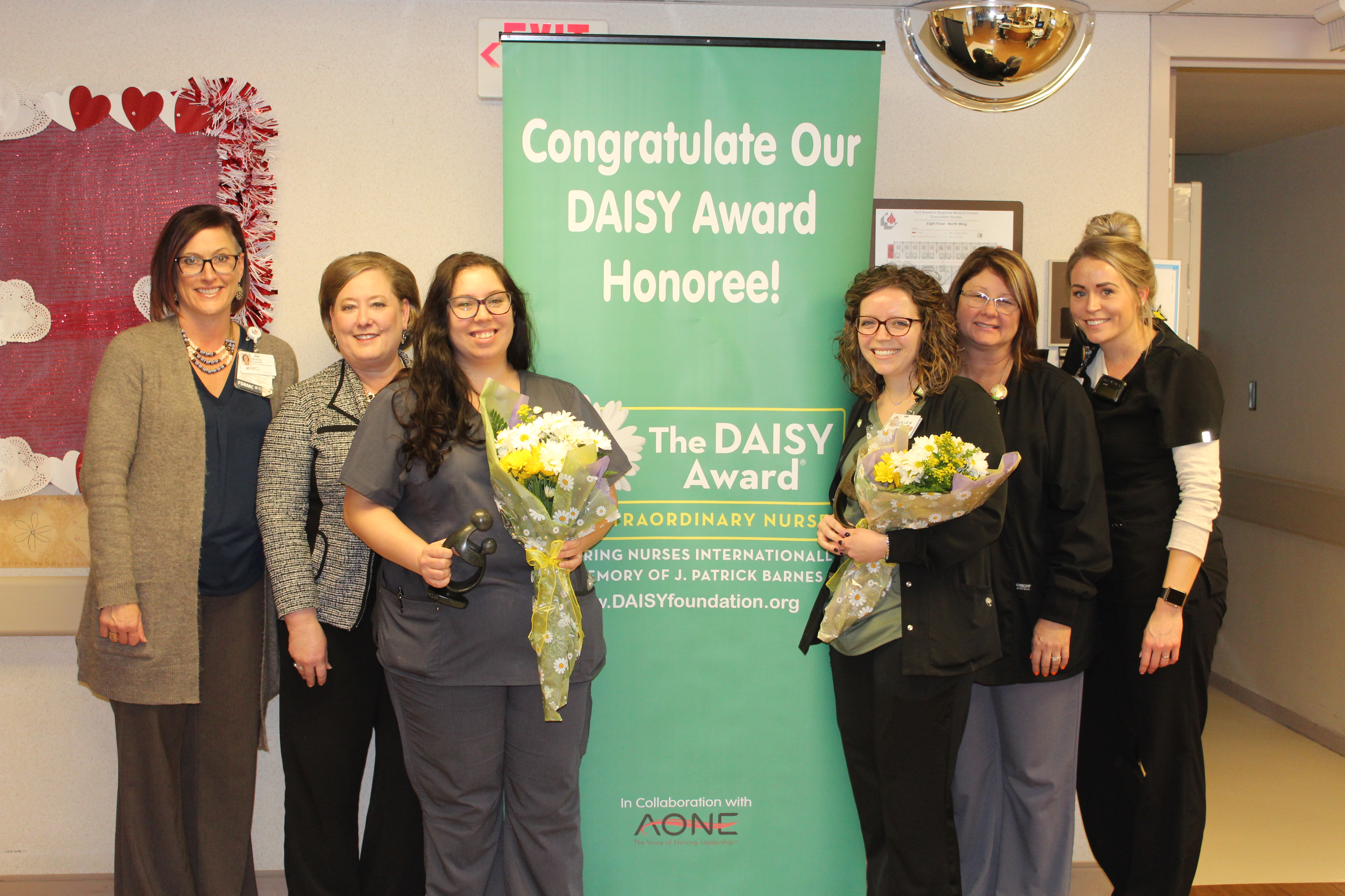 Oncology nurses Felicia Bunch and Callie Wells receiving their DAISY awards