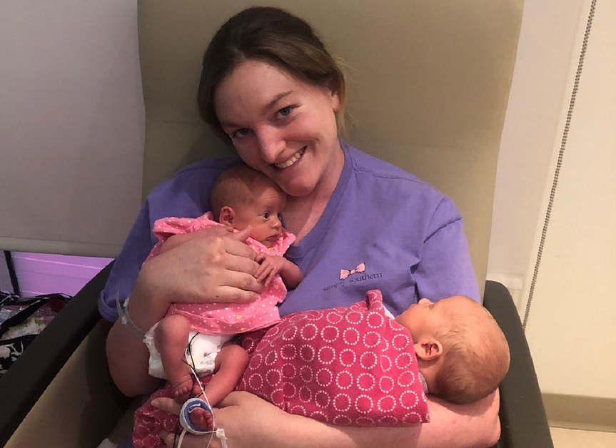 London Hopkins holds her twins, Caroline and Oliver.