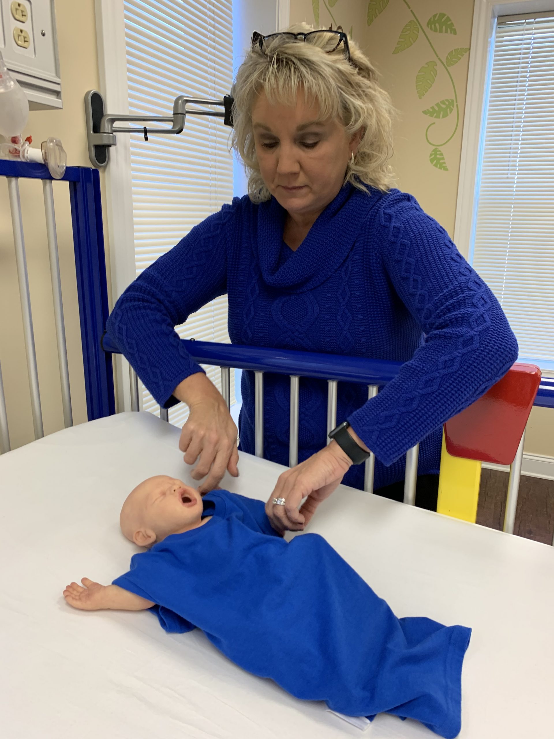 Dr. Lisa Kirkland Vesser with a baby CPR dummy