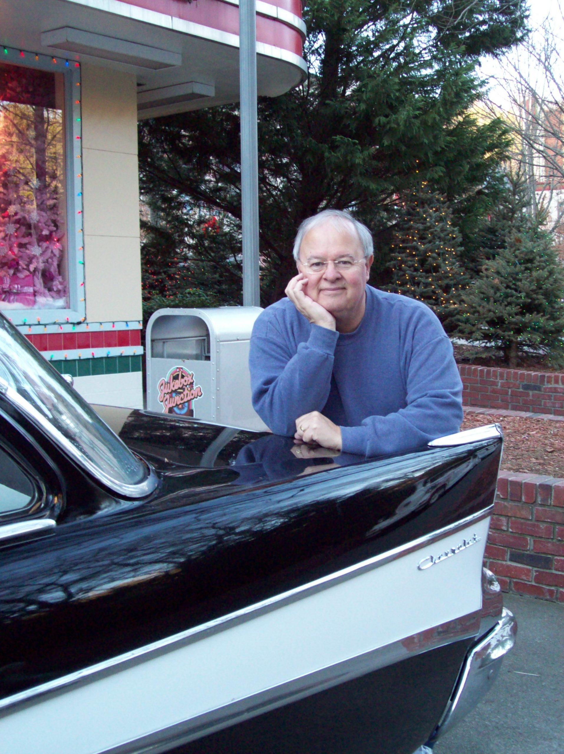 Oscar leans on car Oscar Manuel leans on car