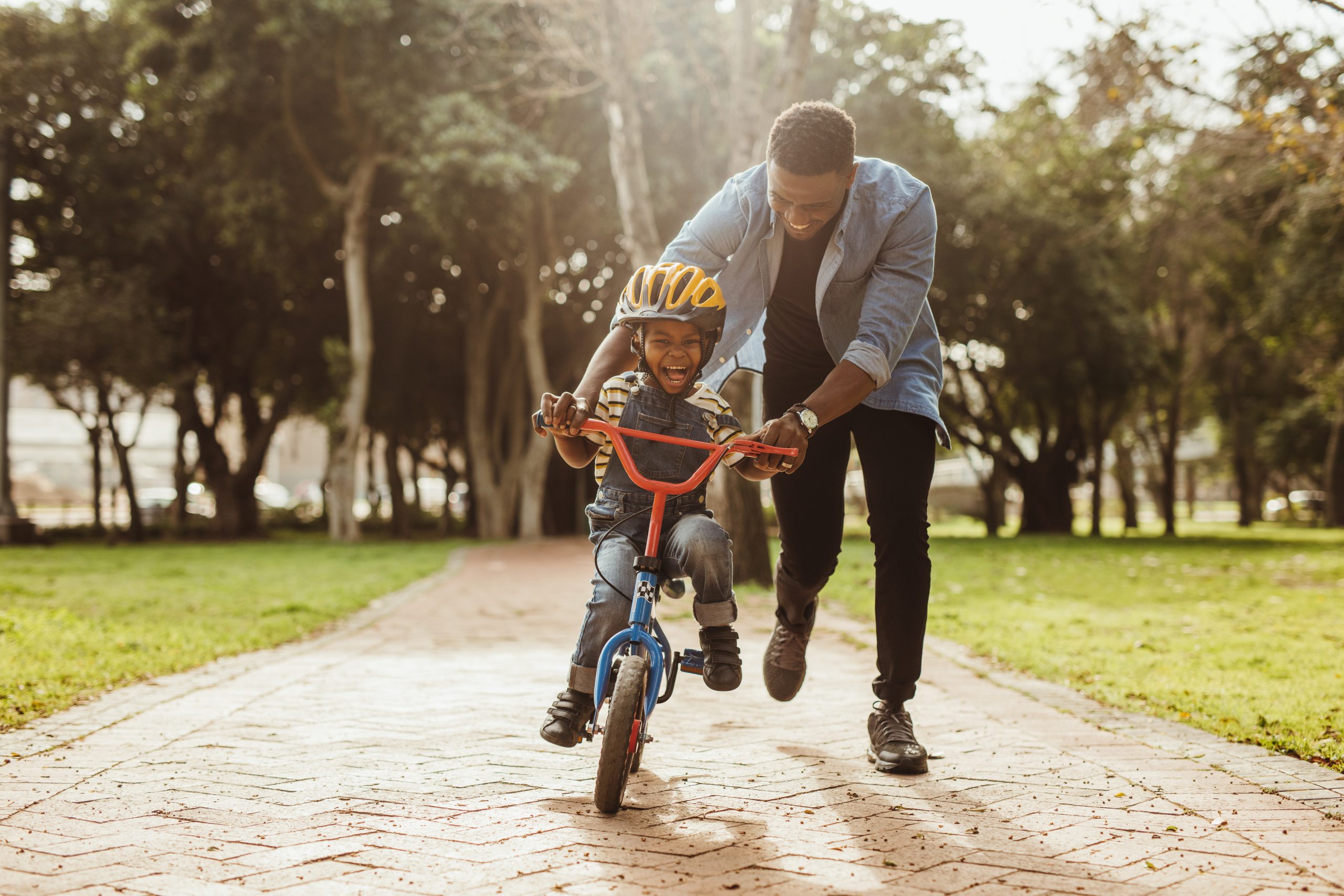 kid riding bike with dad
