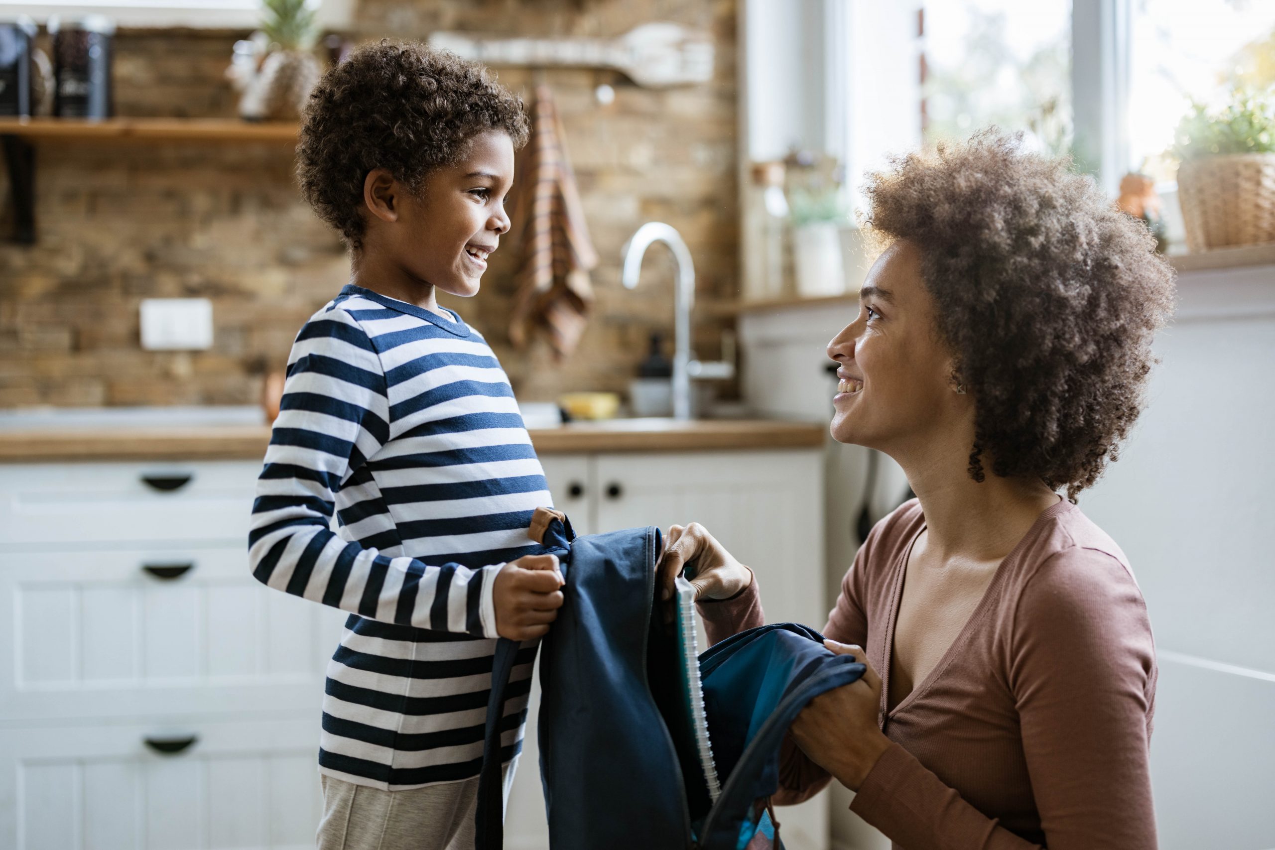 child and mom with backpack