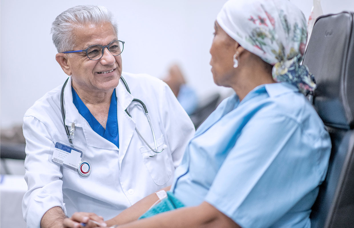 senior male doctor talking to female cancer patient