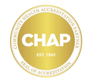 Gold circular seal with CHAP in bold white letters at the center, EST. 1965 below it, and the words Community Health Accreditation Partner and Seal of Accreditation around the edge.