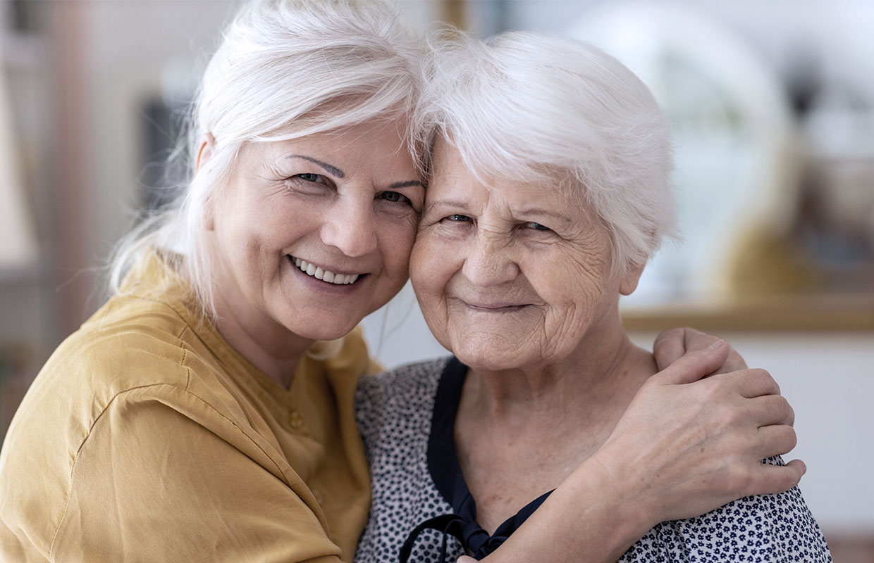 A daughter with her elder mother smiling