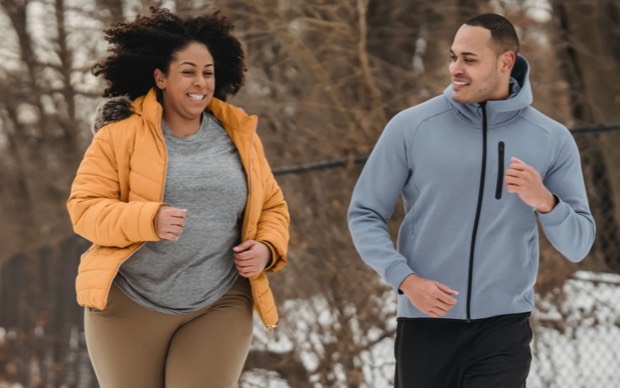 Man and woman jogging in the outdoors.