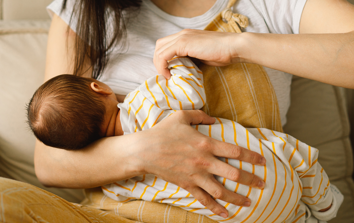 Baby breastfeeding with mother