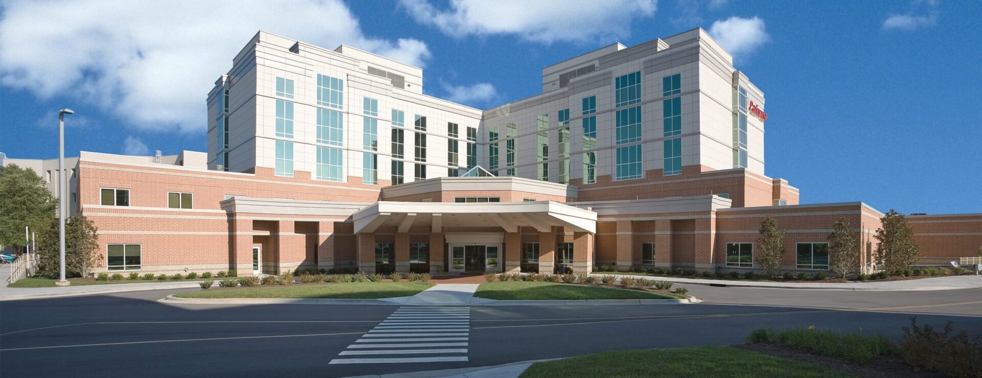 Parkwest Medical Center exterior at main entrance with logo on building.