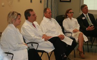 group of doctors sitting in chairs listening to lecture
