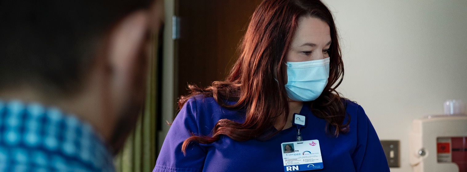 covenant health nurse checks patient insurance forms