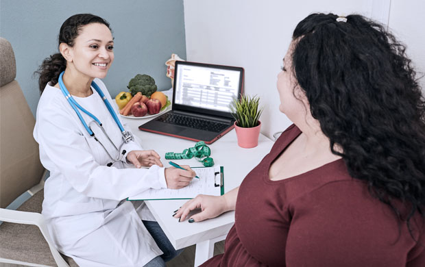 female patient smiling talking to nurse about weight loss options