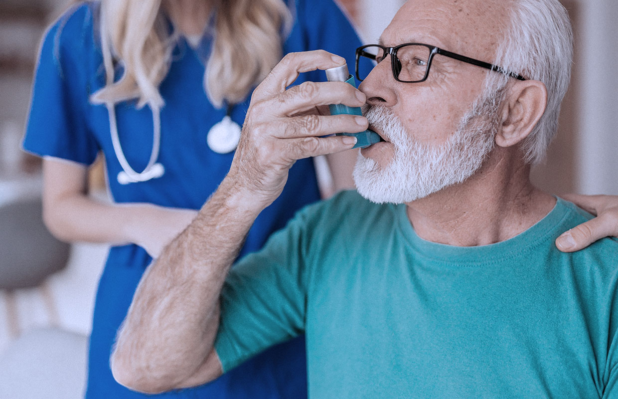 senior male using an inhaler