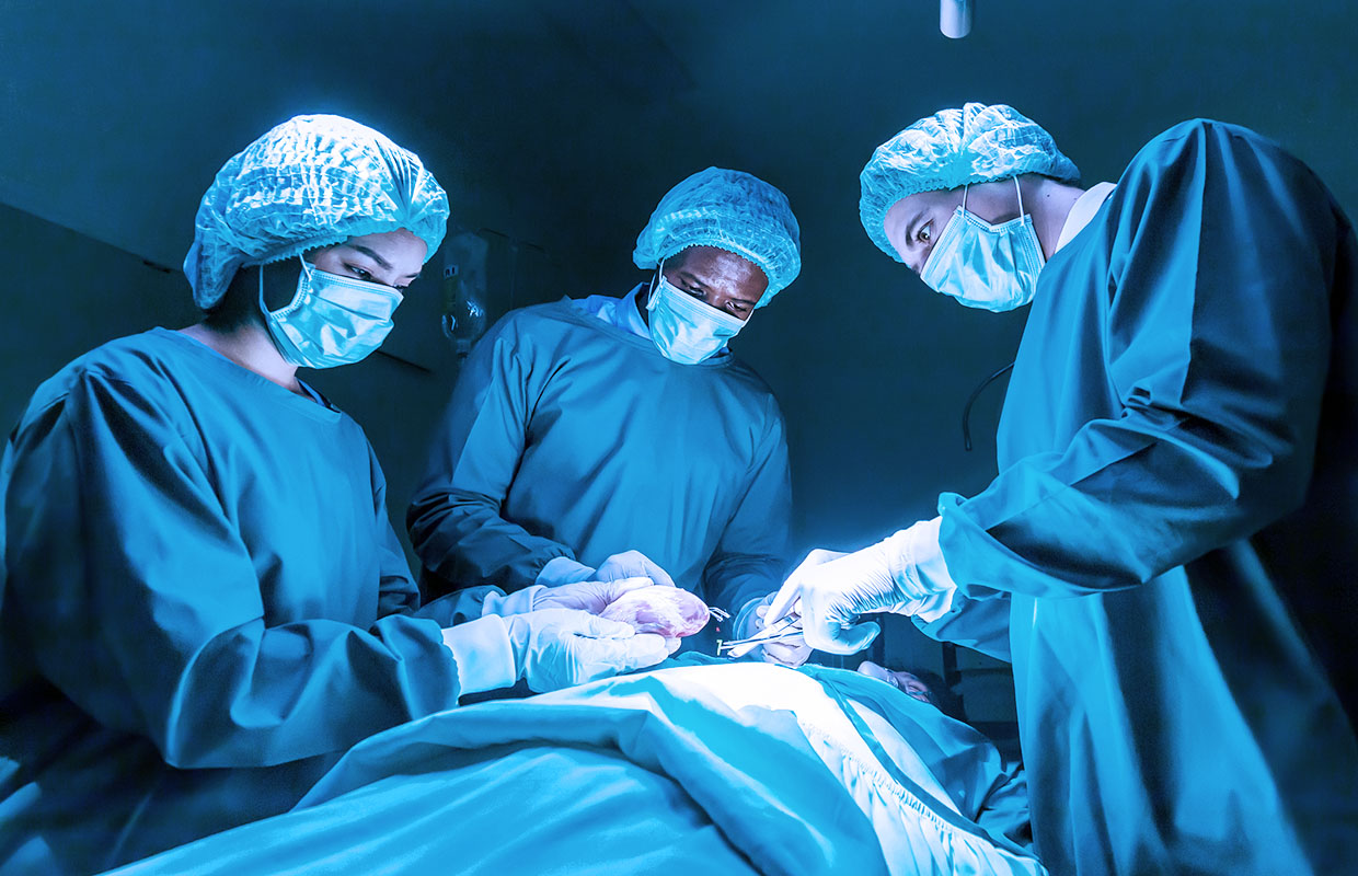 group of three surgeons performing a heart surgery
