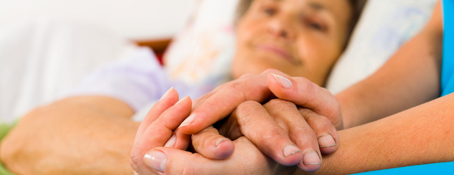 female holding the hand on the nurse