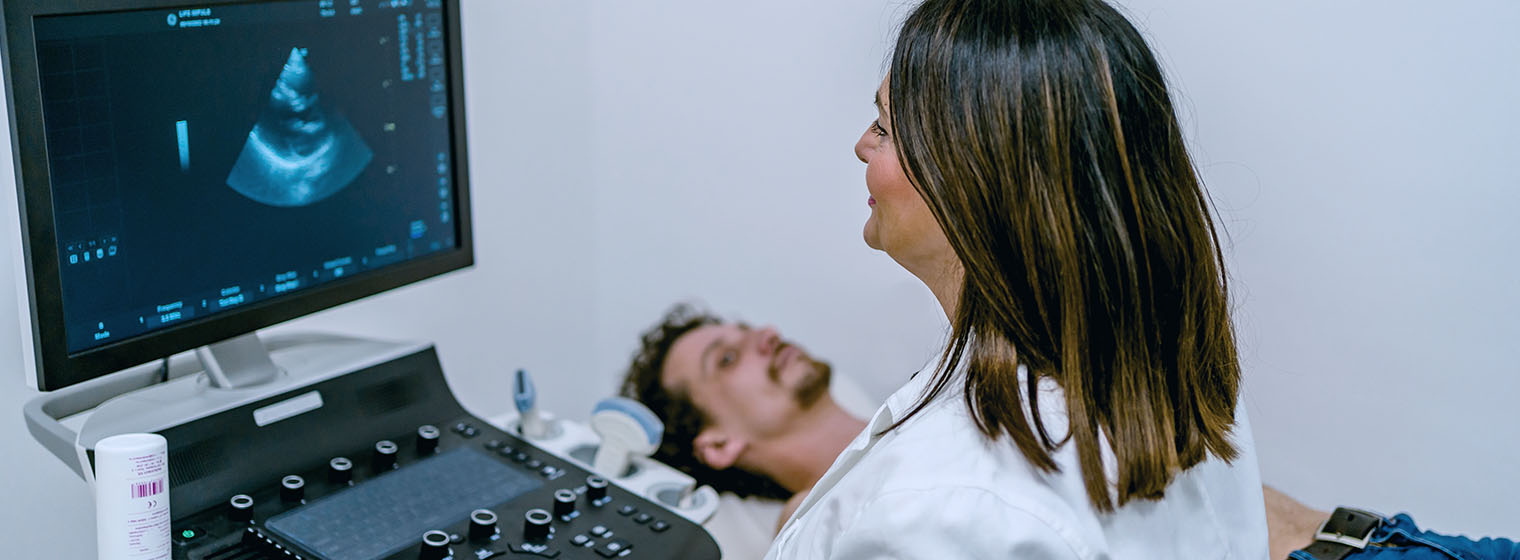 female doctor conducts ultrasound of male patient's heart