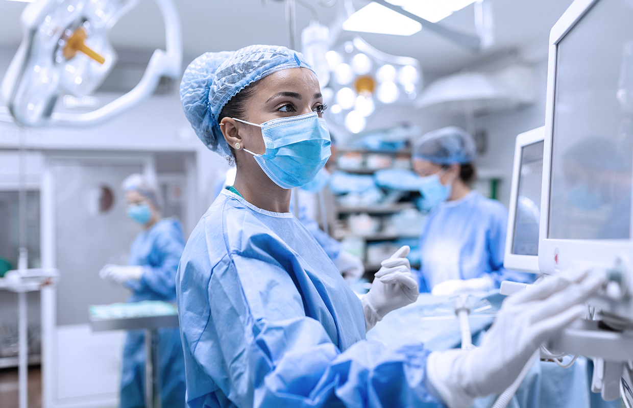 female surgeon looking at monitor in surgical suite