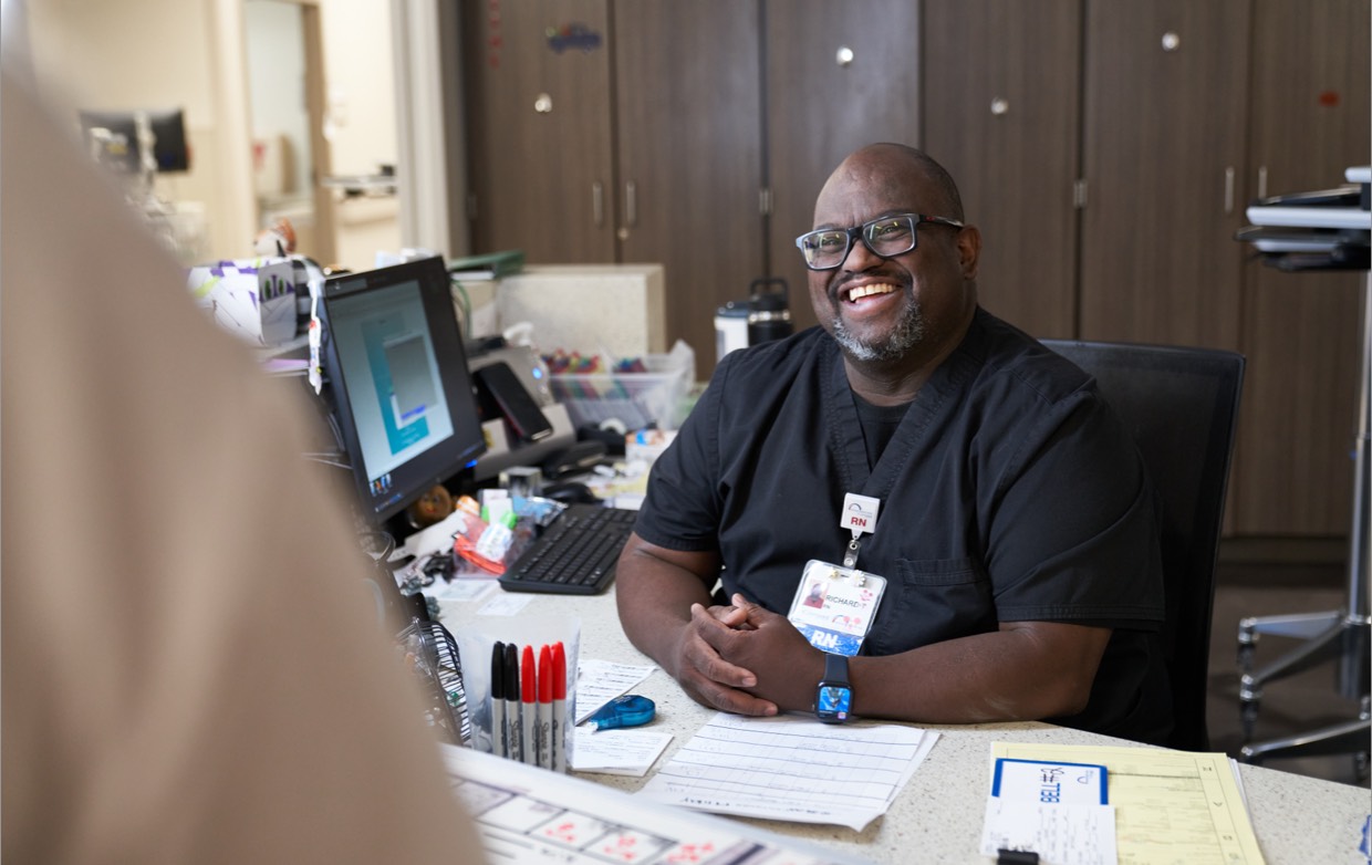 An RN smiling at a coworker.