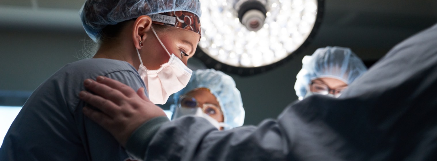 group of surgeons in scrubs in operating room