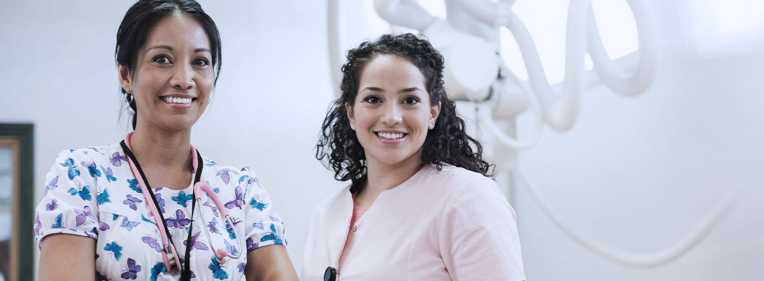 two female radiologists smiling in radiation room