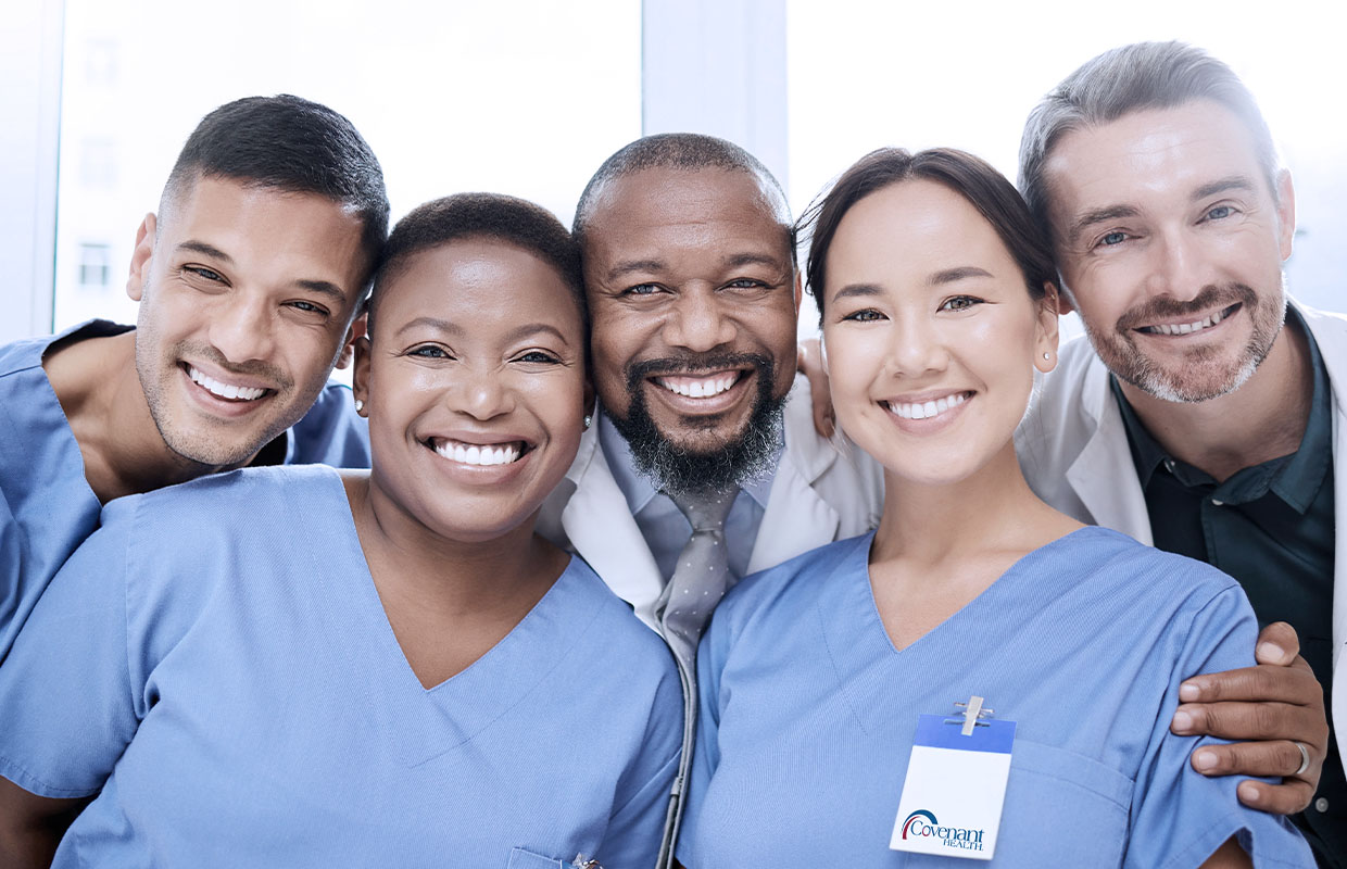 group of nurses in scrubs smiling