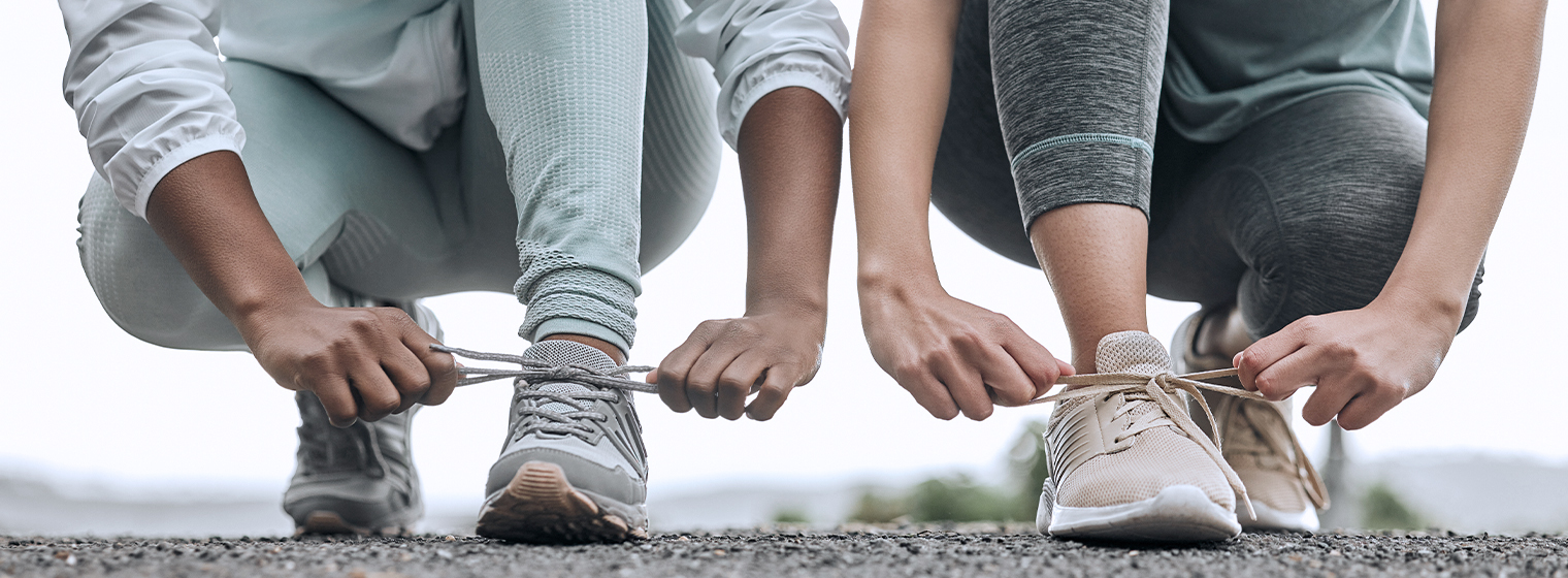 two runners bent down to tie their shoes