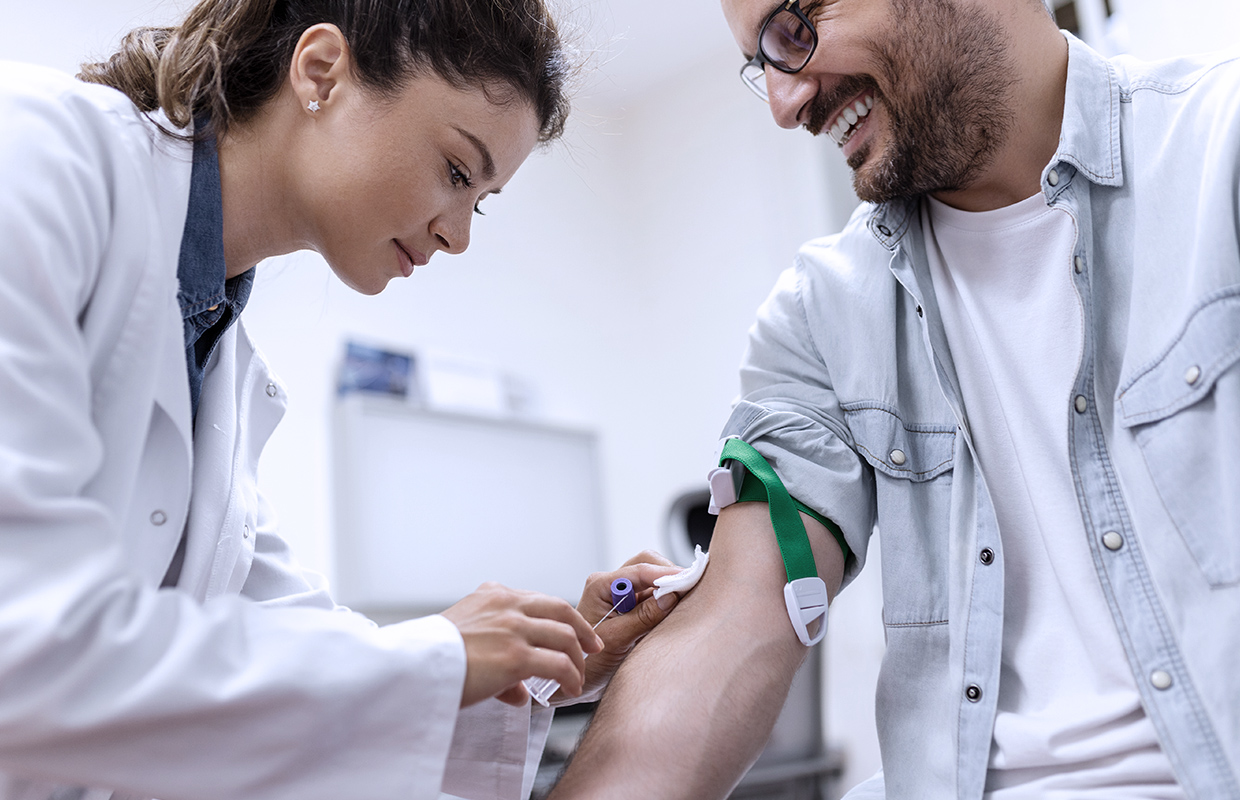 male patient getting blood drawn in laboratory