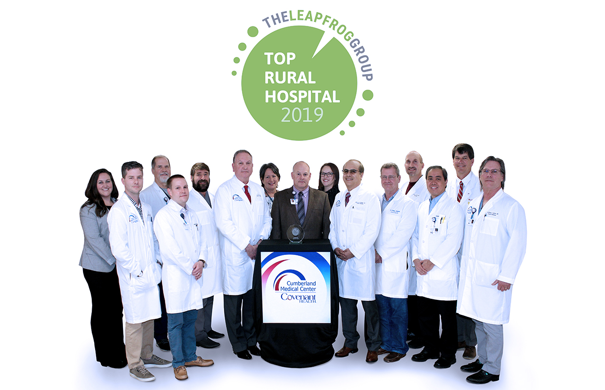 group of doctors standing at a podium with The Leapfrog Group logo behind them