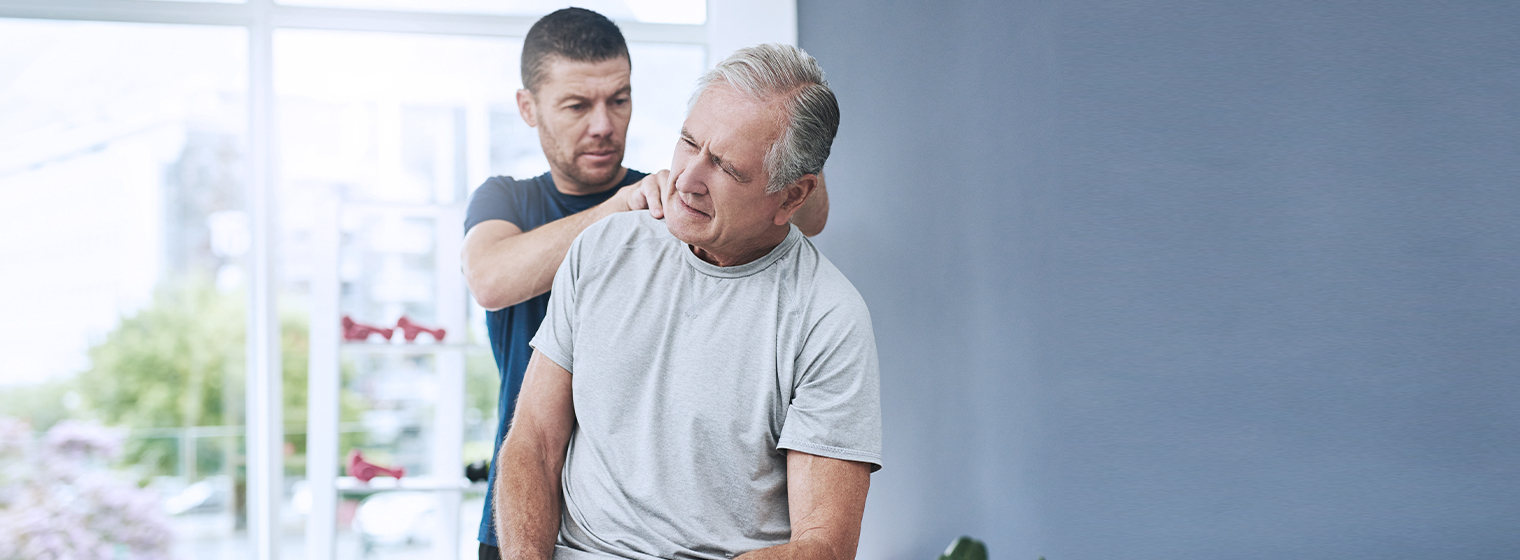 Male physical therapist provides care to a male patient.