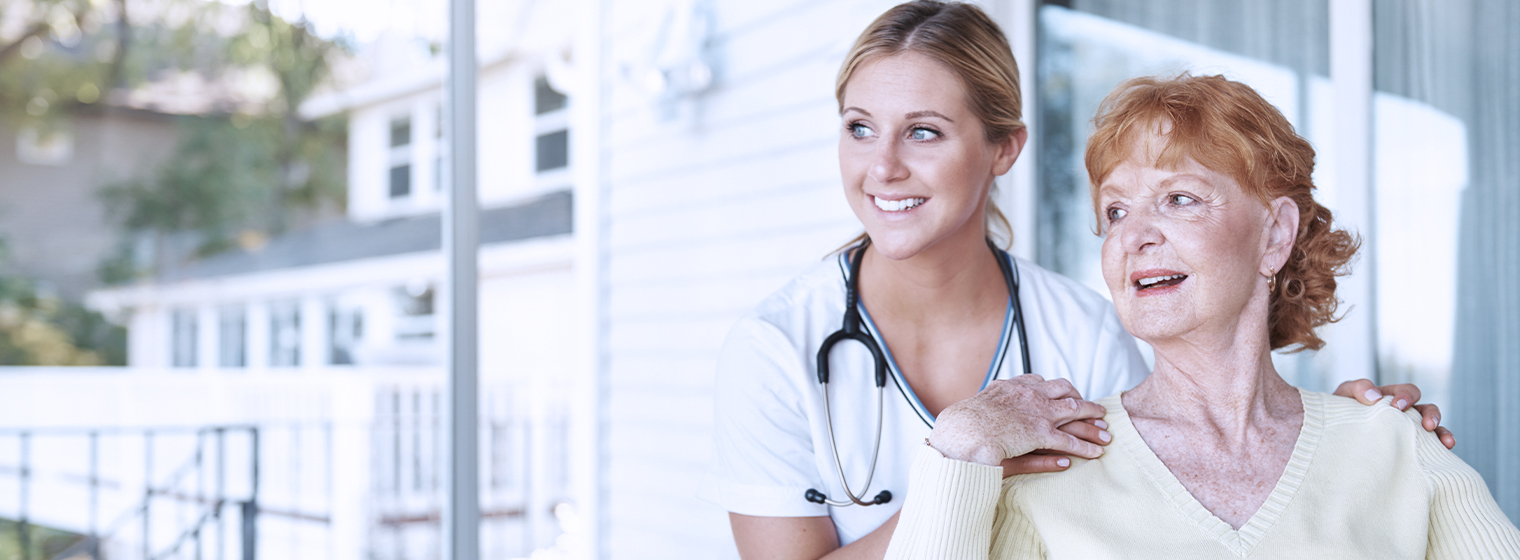 young female nurse with senior woman on porch gazing