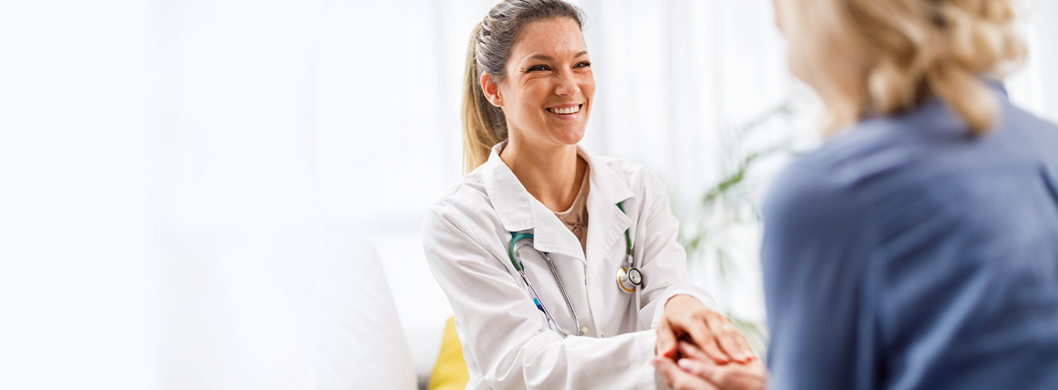 female doctor shaking hands with female patient