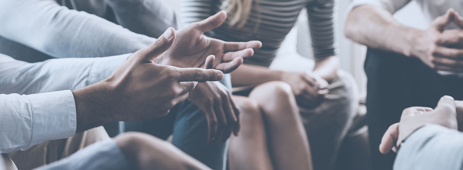 collection of hands in a support group