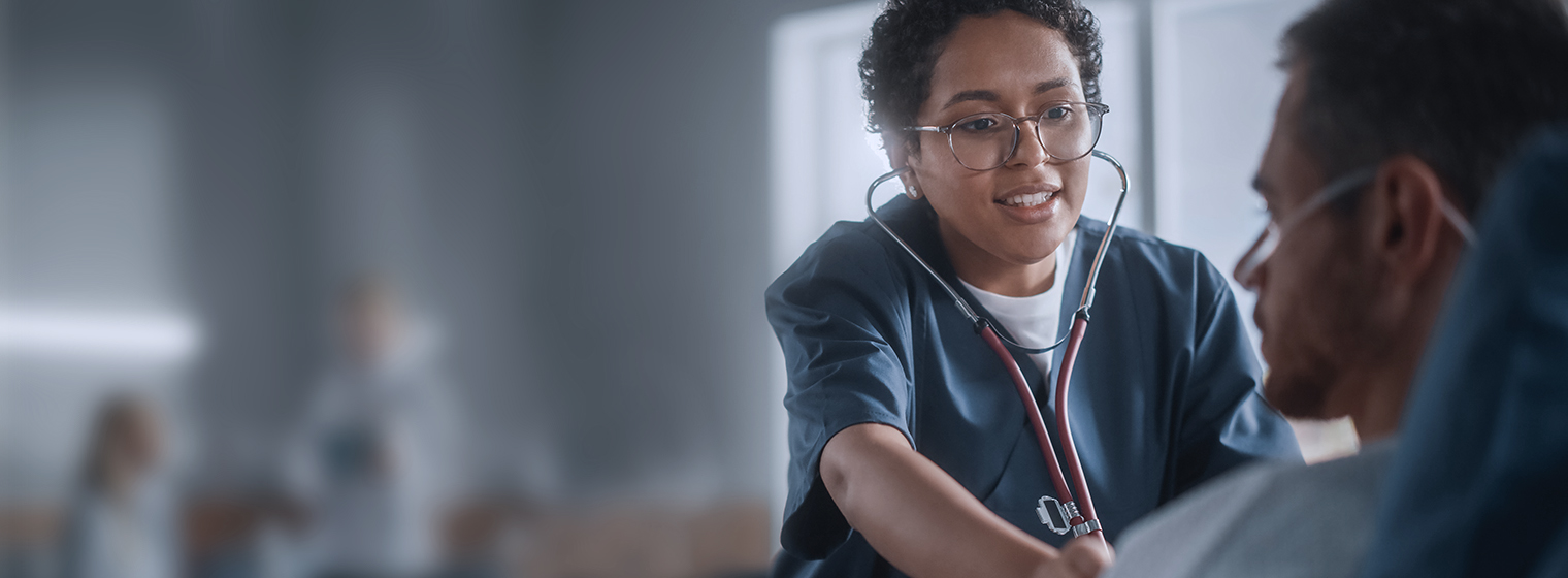 Female provider listens to patient's chest as he breathes