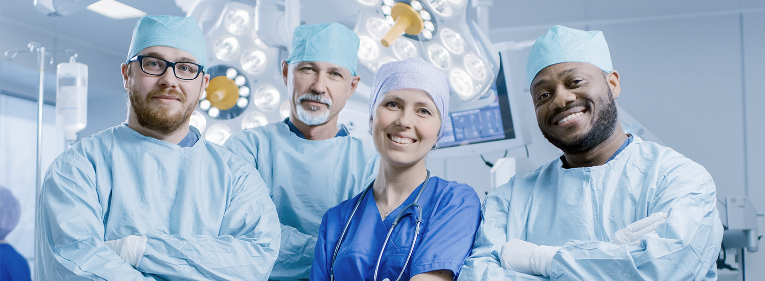team of surgeons smiling in operating room