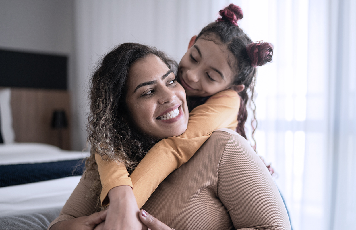 mom with toddler girl on her back