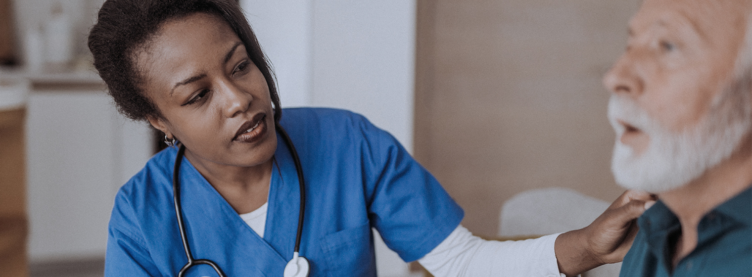 middle age female nurse checking the throat of a senior male