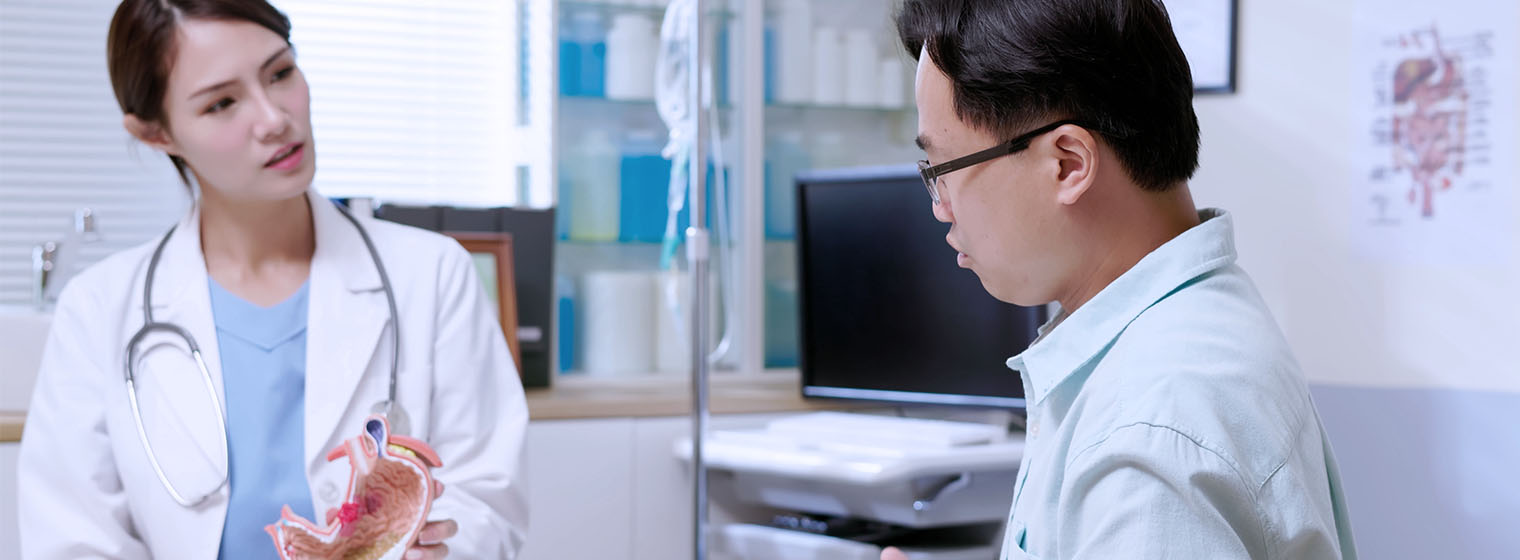 female physician talks to male patient in medical clinic