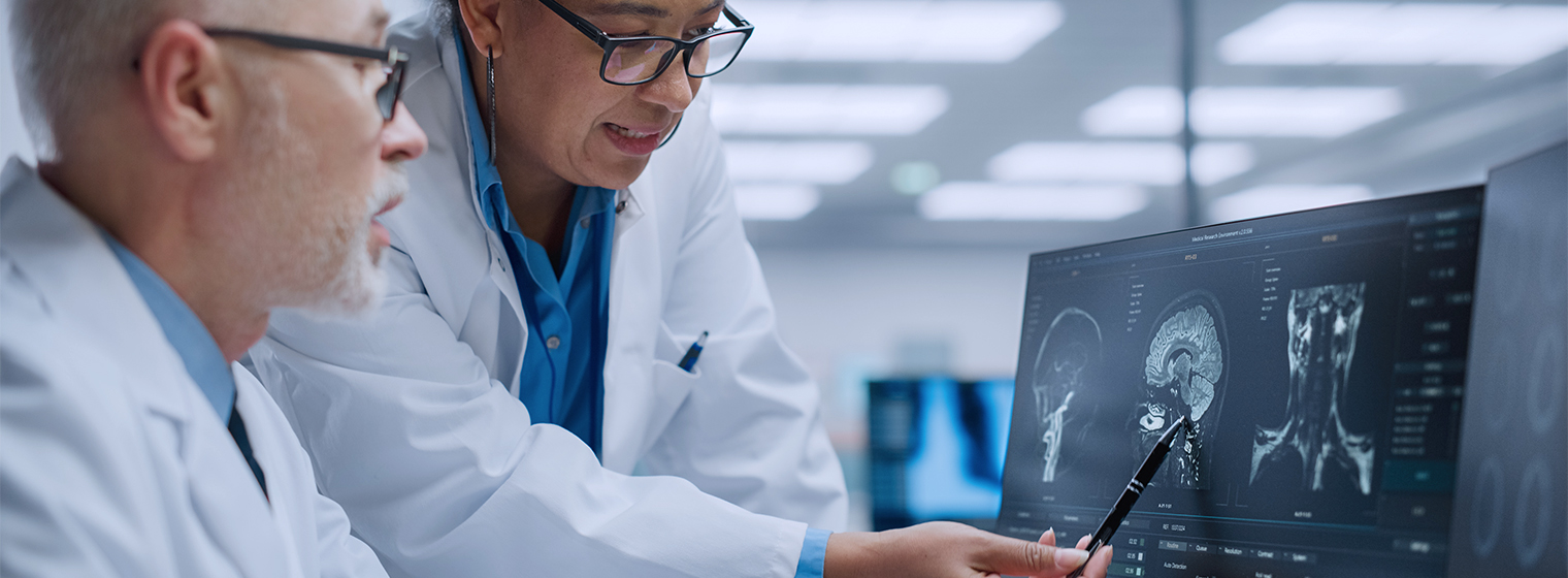 two male doctors reviewing a scan on a computer