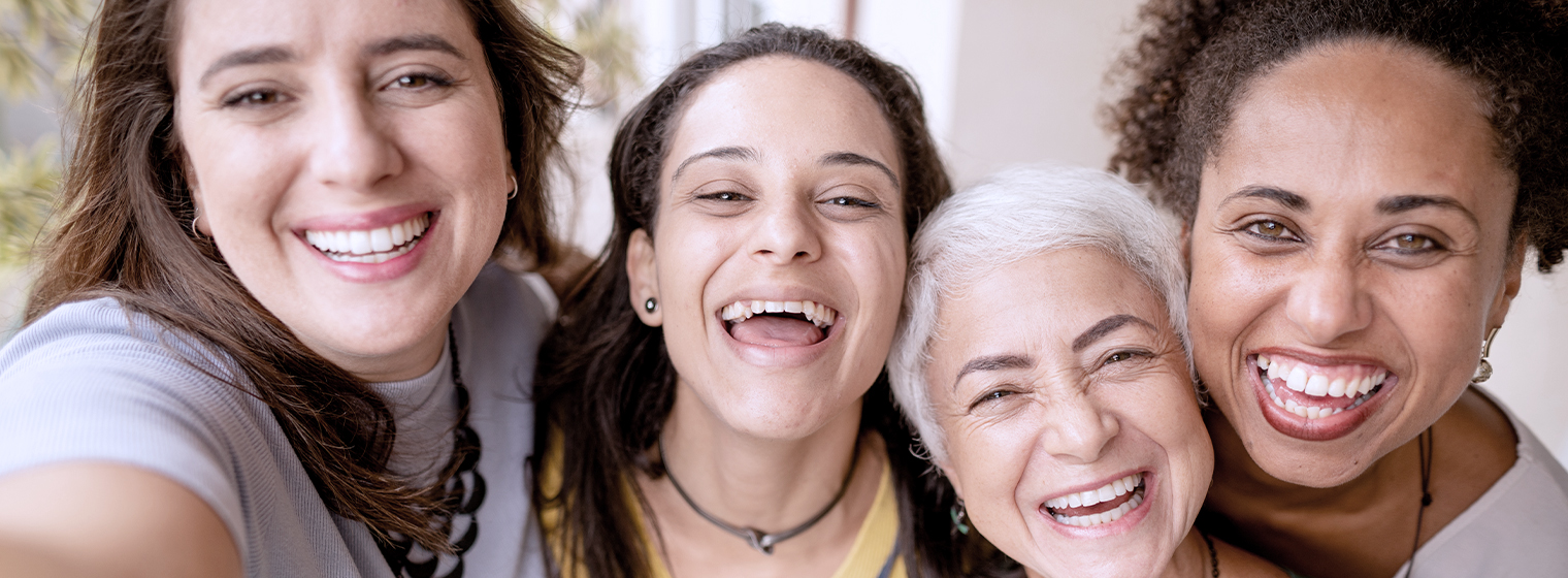 group of women of various ages smiling