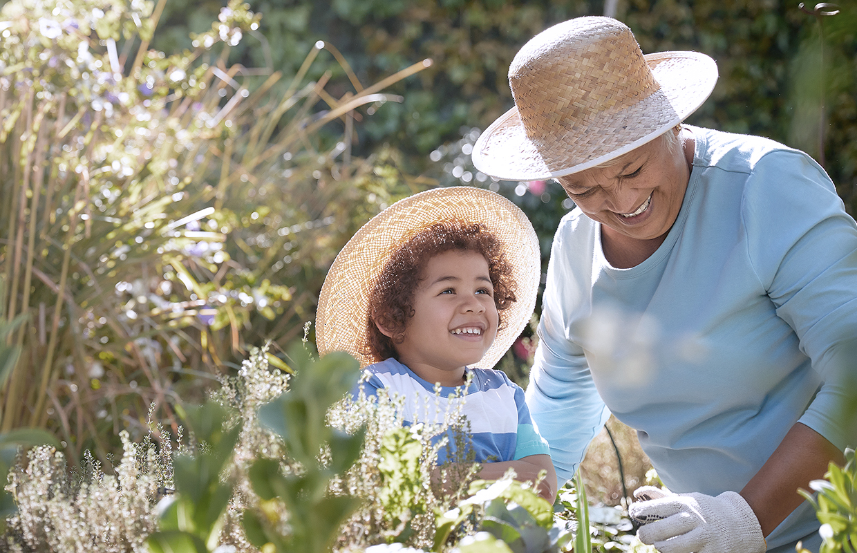grandmother and grandchild doing garden work with hats