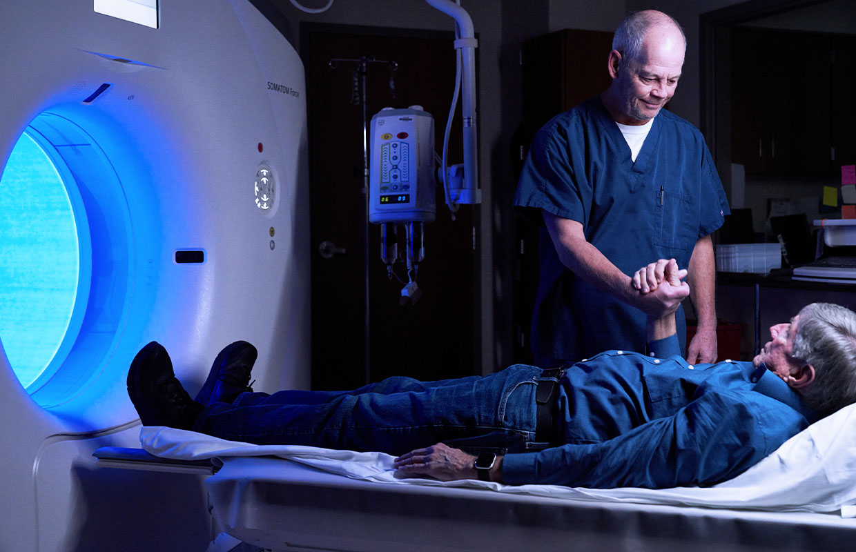 male radiologist preparing a patient for their scan